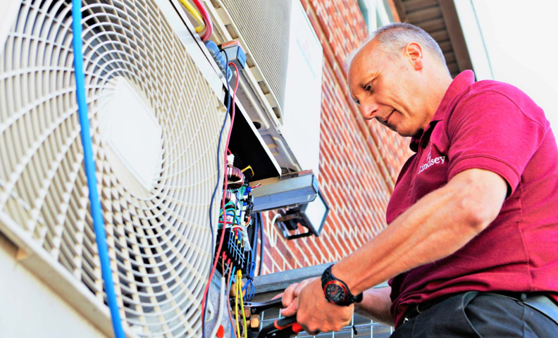 Man working on external air conditioning